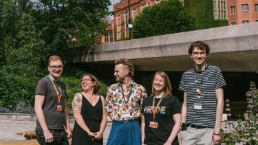 A group of staff members stood on the University concourse