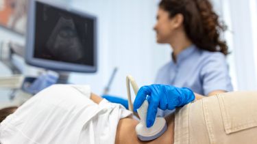 A doctor conducting an ultrasound on a patient's kidneys