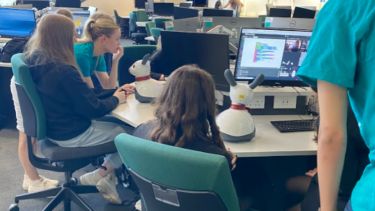 Students being taught how to programme MiRo robots at Girls into Electronics 2022