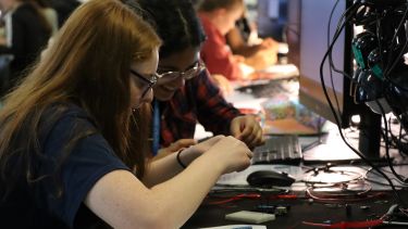 Female students taking part in an electronics lab during a visit to the University of Sheffield