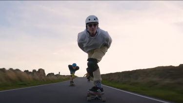 Photograph of alumni Thomas Searle longboarding in the peaks when he was a student at the University of Sheffield