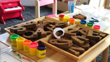A nursery setting with educational toys, and colourful paints