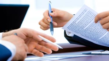 Two individuals working on a text together.