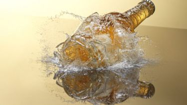 Image of a bottle breaking on a floor