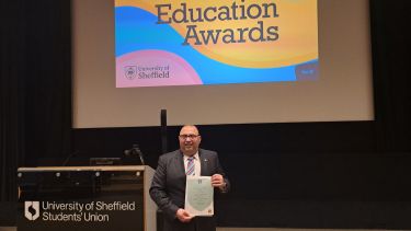 Dr. Mahmoud Masoud with certificate at the 2023 Education Awards