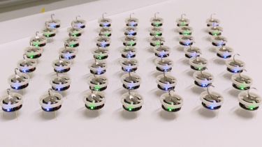 Rows of small robots connected together via elastic links
