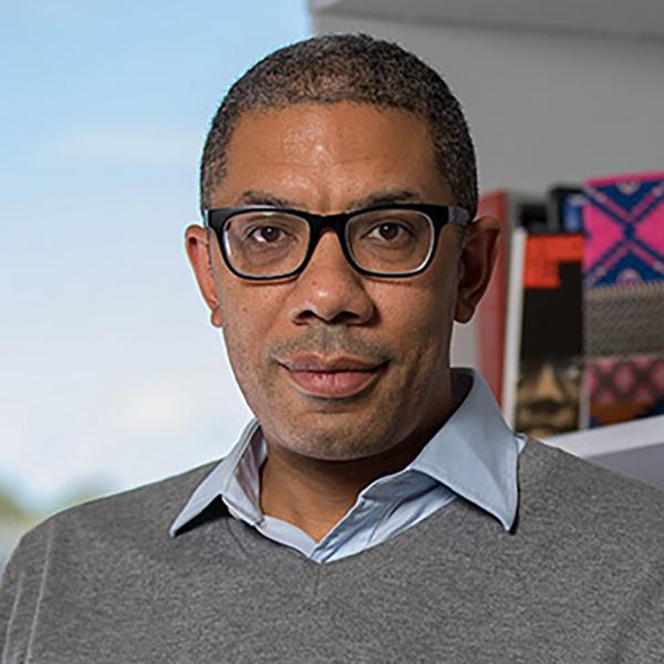 Profile picture of Dr Antony Williams sits infront of a bookshelf and window - image 