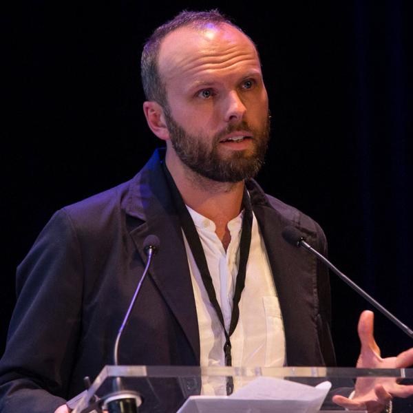 Profile picture of David Forrest standing at podium giving a lecture