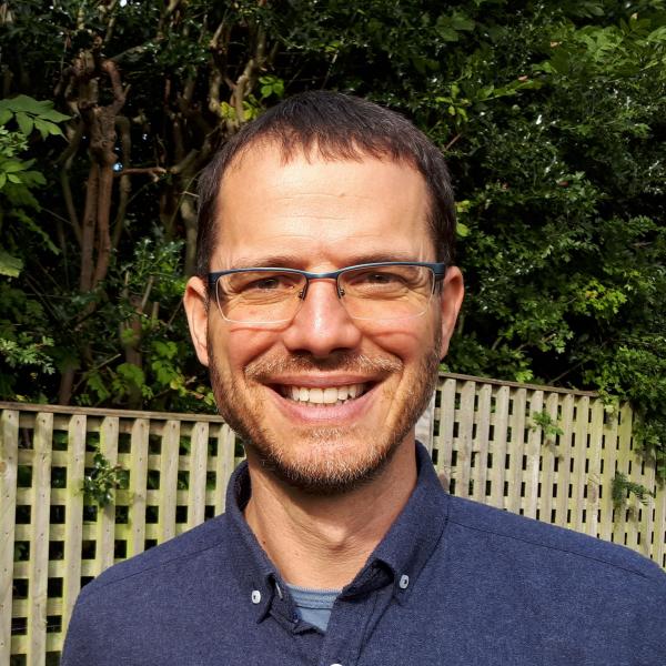 Profile picture of Glyn Williams smiling in a garden