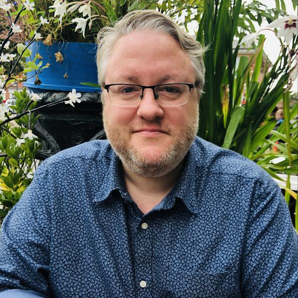 Profile picture of Profile image of Dr Matt Sleat, pictured in front of greenery and flowers