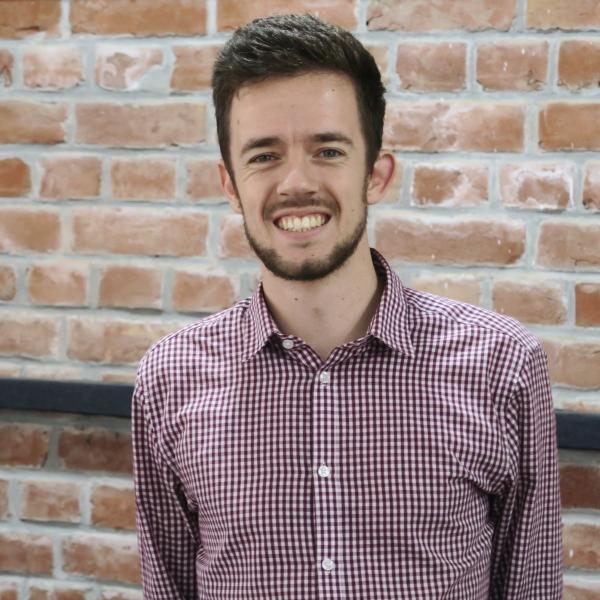 Profile picture of Gregory Cooper portrait against brick wall