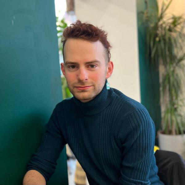 Profile picture of A headshot of Ben Purvis wearing a dark green turtle neck sweater.
