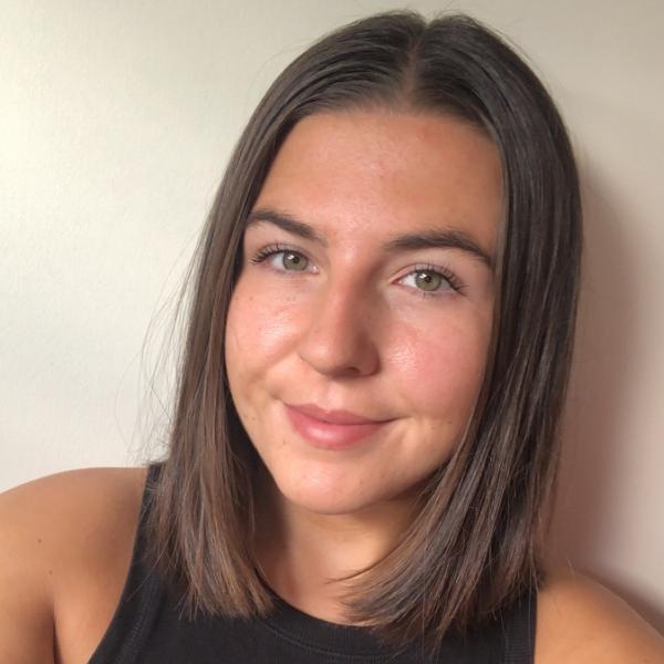 Profile picture of A selfie of Becca Brown against a white wall.