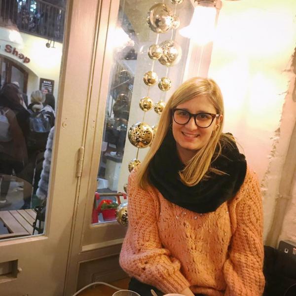 Profile picture of Giota Blouchou wearing an orange jumper and smiling 