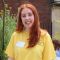 Megan Wood, English Language and Linguistics student, smiling at camera and wearing a yellow t shirt