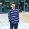 Aneeq ur Rehman. MSc Data Analytics Student. Standing outside the cafe at the student accommodation