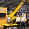 Year in Industry student James Holden at JCB in from of some JCB equipment.