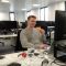 Year in Industry student Joseph Wynne on placement eating a slice of toast.