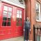 Joanna Jones outside the red doors of ACSE's Amy Johnson Building