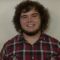 A profile picture of Russell Grim. He has on a tartan shirt.
