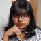 A profile photograph of masters student Umanga Perera. She is holding a pen.