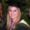 Student Alice May wearing cap and gown at graduation