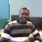 PhD student Divine sits in his PhD office