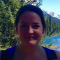 A profile photo of Emma Blakey stood in front of a lake