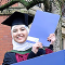 Nora stood in front of the Firth Court sign at her graduation