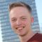 Headshot of Declan Maurice stood in front of the Arts Tower smiling