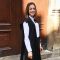 Melis in front of a grand building at the University of Oxford