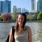 Poltics student Lucy Davis-Jenkins in front of body of water and skyscrapers - Germany