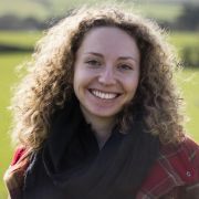Image of PhD student, Teresa, in a green