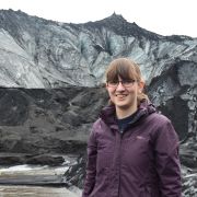 Dr Frances Butcher standing in front of a glacier