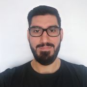 A head and shoulders photograph of Ignacio Perez Sepulveda, wearing a black TV shirt and a black framed glasses.