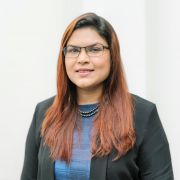 Sharmin Rahman wearing a blue top and black blazer.