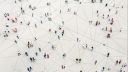 Bird's eye image of people stood apart from one another with a series of lines on the ground connecting them together