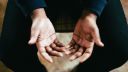 A person's hands on their lap with palms pointing upwards