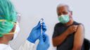 Close-Up Of Doctor Preparing Syringe For Patient - stock photo
