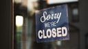 A shop sign saying 'sorry we're closed'