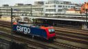 A single freight train carriage in a train station 