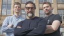 Three members of Opteran pose for a photo