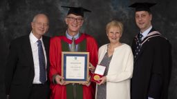 Dr Keith Clarkson receiving the Distinguished Alumni Award