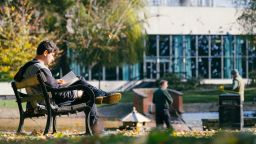 Student reading in Weston Park