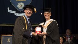 Sarah Evans receiving her Distinguished Alumni Award from Professor Mike Hounslow