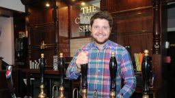 Alumnus Thomas Gill behind the bar at The Closed Shop pub