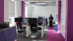  A student walking to her desk in the doctoral centre