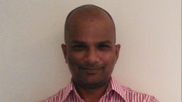 Headshot of professor bhavani shankar stood with arms folded against a cream background