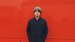 Student stands out against red background