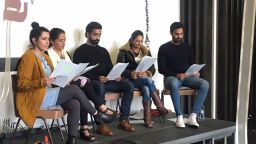A panel sat in front of an audience
